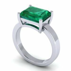 An emerald stone engagement ring in white gold.