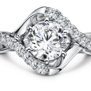 An oval diamond halo engagement ring in white gold.