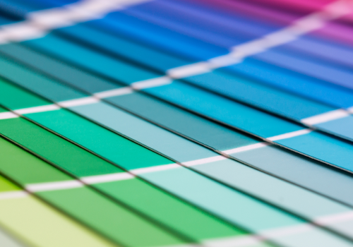 A close-up spread of a wide variety of Pantone color sample cards.